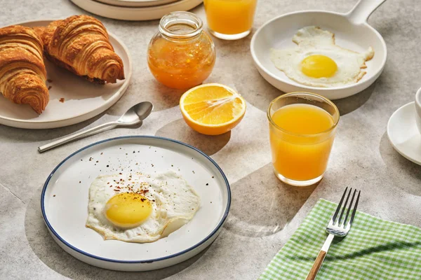 Continental breakfast. Fried eggs and sausage with croissants an