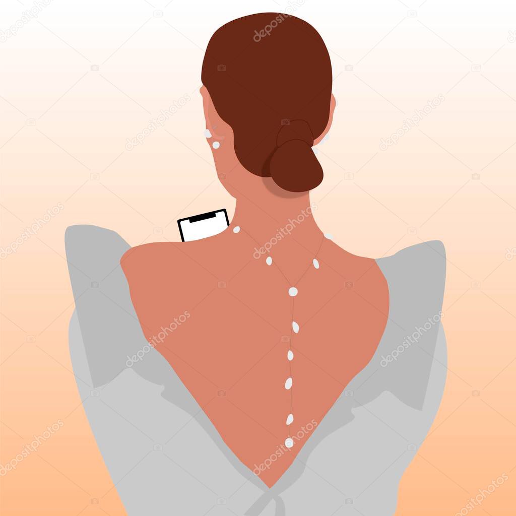 Brunette Girl with Smartphone in a white dress standing with her Back with a Pearl decoration around her neck and ears.
