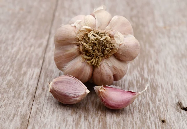 Garlic with leaves of parsley isolated on white