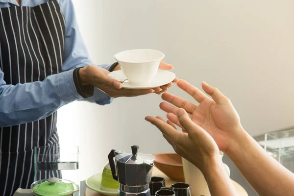 Close up Hands of Staff Serving Customer In Coffee Shop.