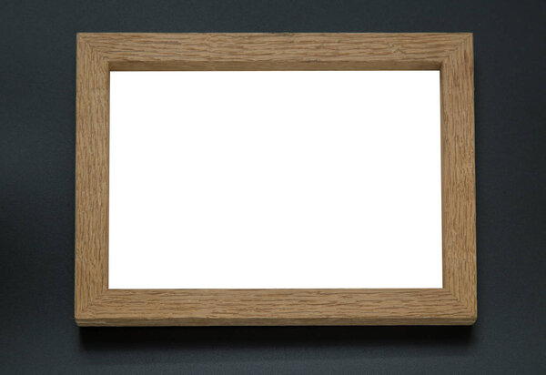 Blank wooden photo frame on black background.