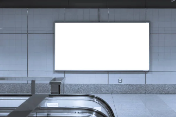 Blank billboard posters in the subway station for advertising.