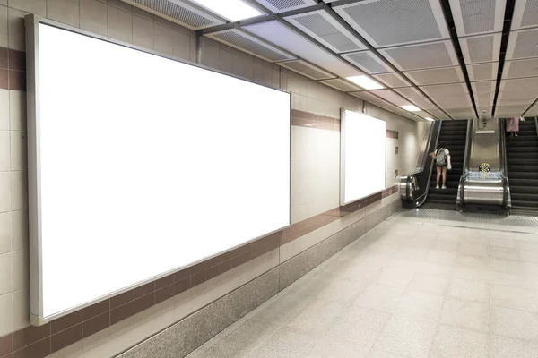 Blank billboard posters in the subway station for advertising.