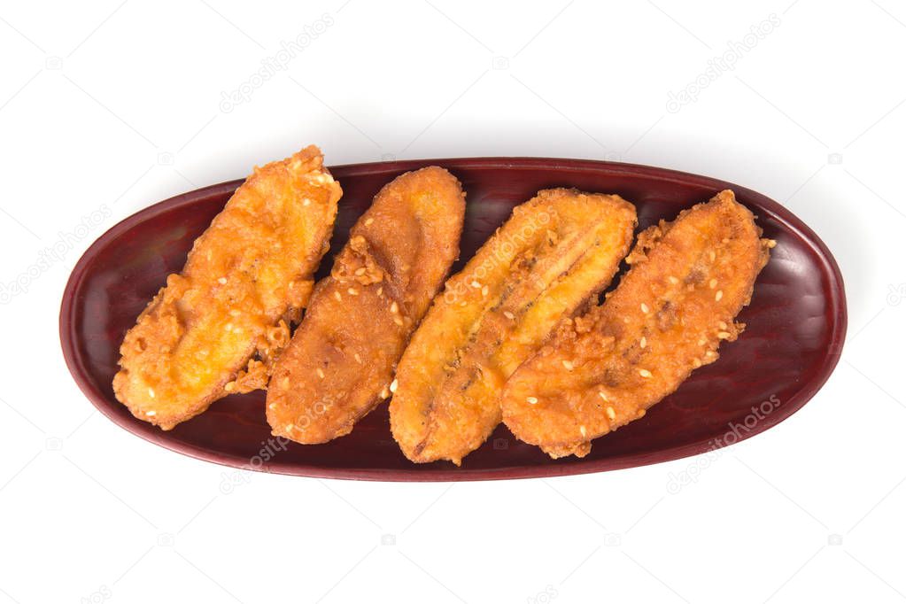 Fried bananas in plate isolated on white background, Kluay Tod - Thai dessert.