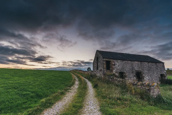 Bulutlu gökyüzü arka planında terk edilmiş binanın görünümü 