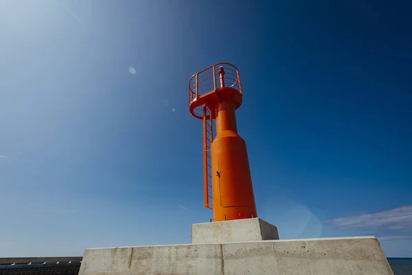 Small Modern Red Lighthouse Pole Renovated Concrete Mole Isolated Blue — 스톡 사진