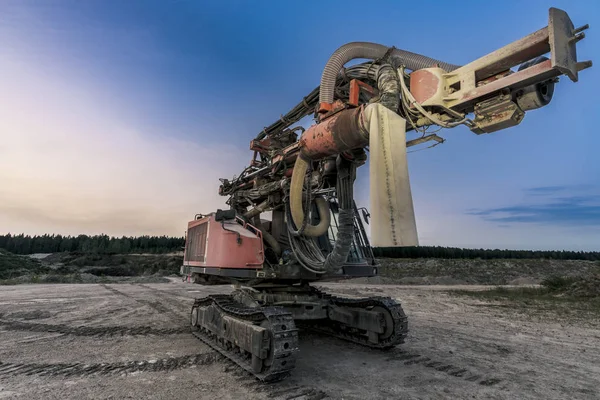 Old heavy machine in quarry.