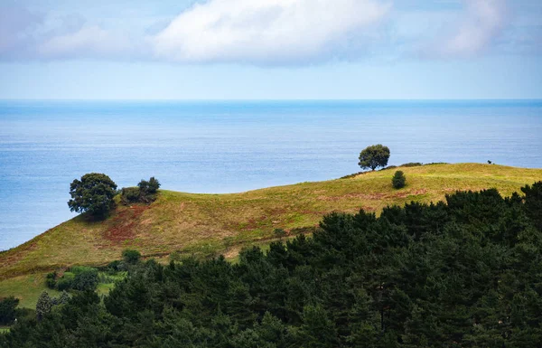 Landscape with hill, forest, sea and blue sky with clouds. Irun, Basque Country, Spain. Camino de Santiago