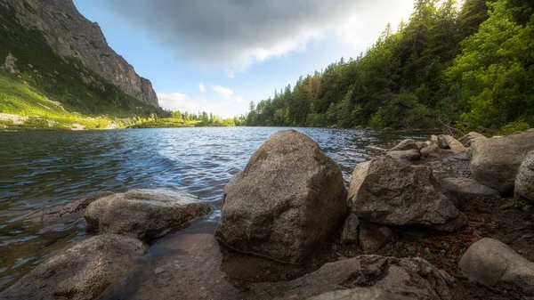 Mountain Lake with Rocks in Foreground. Poprad Tarn, High Tatras, Slovakia.