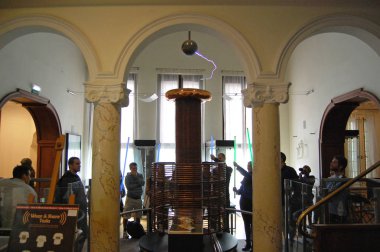 Visitors are making an experiment with the High-frequency Oscillator in the Nikola Tesla museum in Belgrade, Serbia. clipart