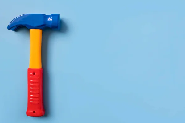Üniformalı mavi arka planda plastik çekiç eğitimi veren çocuklar. metin boşluğu, metin için bir yer.