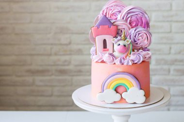 Tatlı pembe doğum günü pastası, sevimli tek boynuzlu at, zencefilli prenses şatosu, gökkuşağı ve kremalı bulutlu küçük bir kız için..