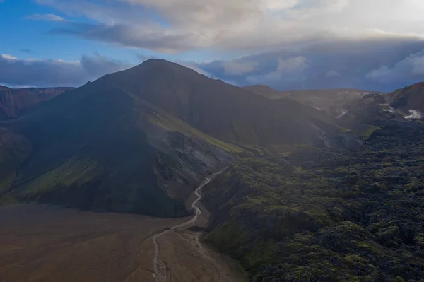 Islandia en septiembre de 2019. Great Valley Park Landmannalaugar, rodeado de montañas de riolita y nieve sin derretir. En el valle construyó un gran campamento. El concepto de giras mundiales . — Foto de Stock