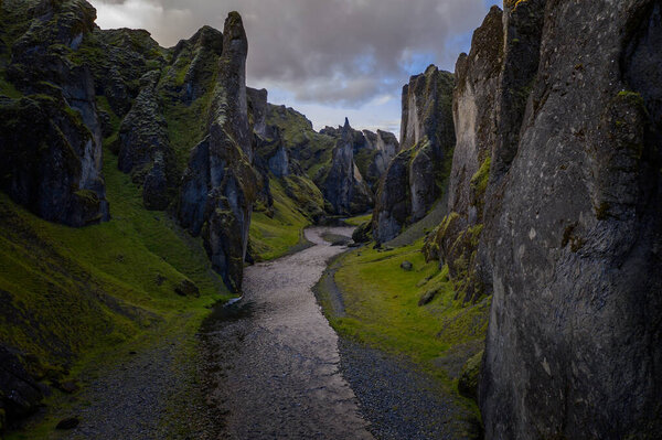 The most picturesque canyon Fjadrargljufur and the shallow creek, which flows along the bottom of the canyon. Fantastic country Iceland. September 2019. aerial drone shot