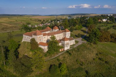 Göl kıyısındaki ortaçağ şatosunun manzarası. Mekan Svirzh, Ukrayna. Uçan kuadkopterden görüntüle .