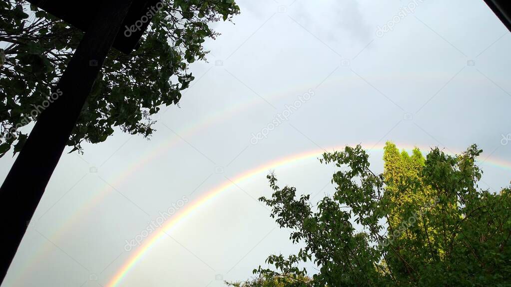 The rainbow came out after the rain in my neighborhood