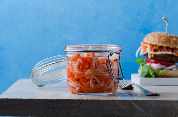 Traditional fermented foods -   kimchi with carrot on marble table