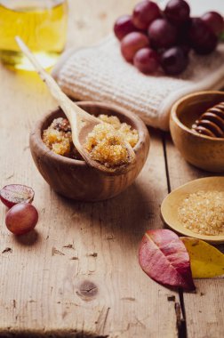 Ingredients for body scrub of brown sugar with grape and  oil, eco bio friendly cosmetic for skin care. clipart