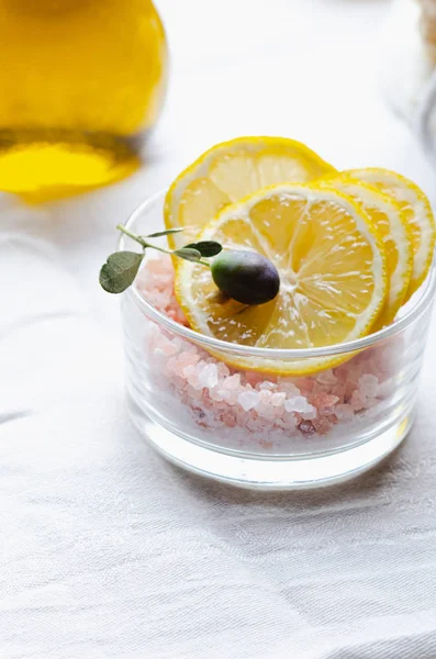 Ingredients for body scrub of pink salt with lemon and olive oil