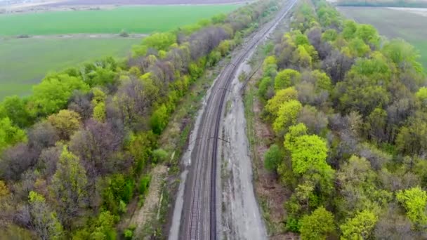 Voar aéreo sobre os caminhos de ferro dobrados na tarde de primavera. Tomado por drone — Vídeo de Stock