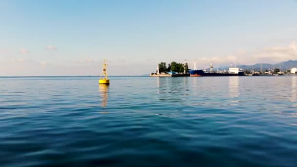 Flight over water to lighthouse and tanker in the port Batumi. Taken by drone — Stock Video