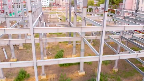 Aerial flying rise above the metal frames of the building under construction — Stock Video