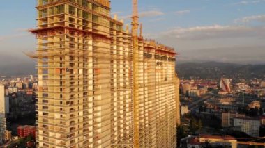 Gün batımında inşaat sırasında gökdelen binasının havadan görünüşü