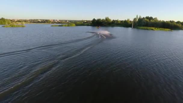 Young man fast rides on a wakeboard. Aerial view — Stock Video
