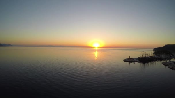Aerial view of sunrise from the sea. Aerial slow flight left. — Stock Video