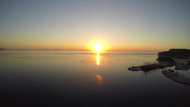 Aerial view of sunrise from the sea. Aerial back flight. — Stock Video
