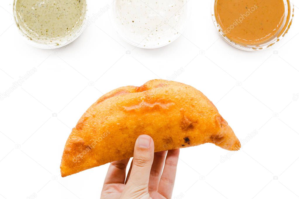 Empanada creative layout on a white background. Venezuelan and Colombian instagram food composition. Top view, flat lay. Fried empanadas from America with different sauces to dip