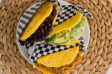 Beef, avocado and beans arepas, traditional from Venezuela clipart