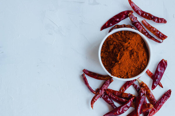 Paprika and dry chiles on a white background with space for text