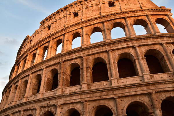 Photo of Roman Coliseum at sunset. Bottom view.