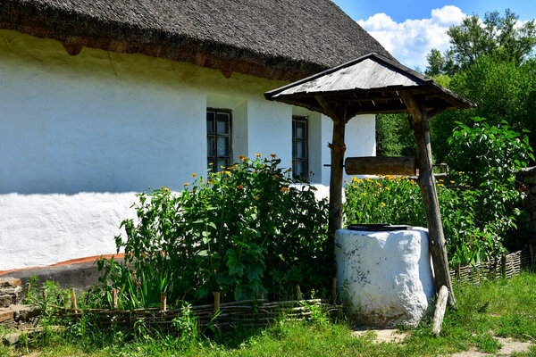 Kyiv, Ukraine - July 4, 2020: Pyrohiv open-air museum of folk architecture: Old Ukrainian house and well.