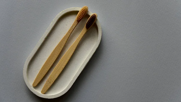 Two Bamboo Toothbrushes Concrete Tray Blue Paper Background Zero Waste — Stock Photo, Image