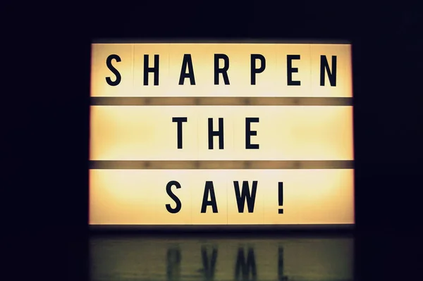 \'Sharpen the saw\' text glowing on a lightbox