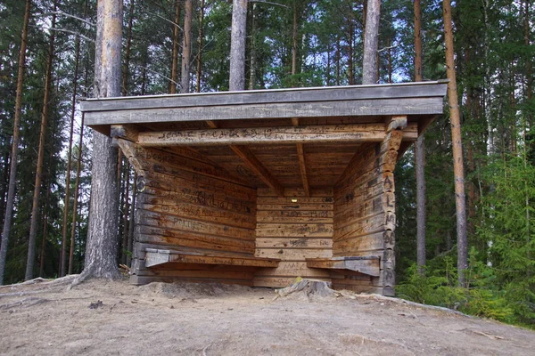 Mountain shelter against a forest background.