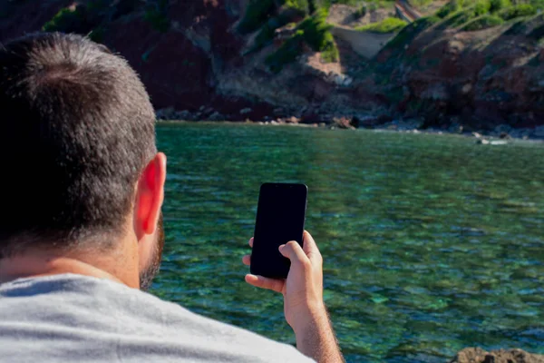 Young man photographing a cove of mallorca — Stock Photo, Image