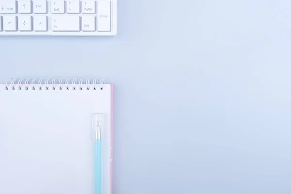 Creative flat lay photo of desktop. Notebook on white color background. Top view with copy space, flat lay photo.