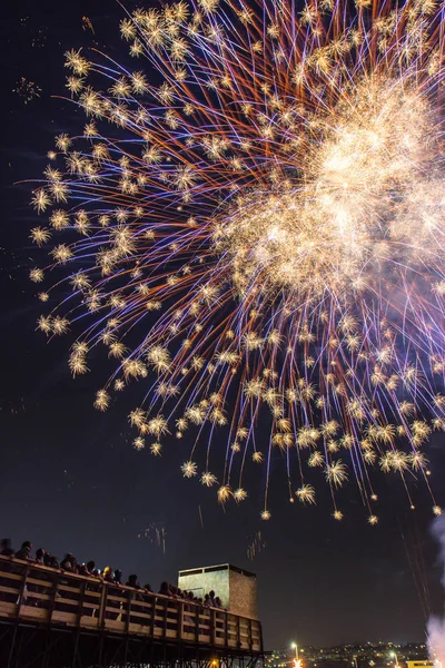 People watch fireworks during a feast in Catania, Sicily