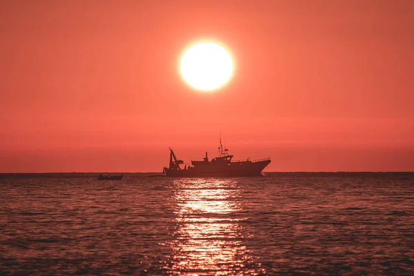 Boat and sunrise, fishing boat in the sea