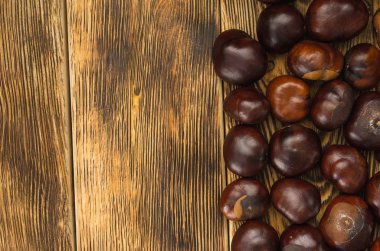 birçok kestane meyve bir ahşap masa yukarıdan sol kopya alanı üzerinde yer alır.