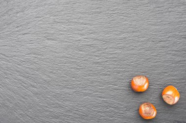 Üç fındık fındık. üstten görünüm. Kayrak bir tepside. sağ alt köşede.