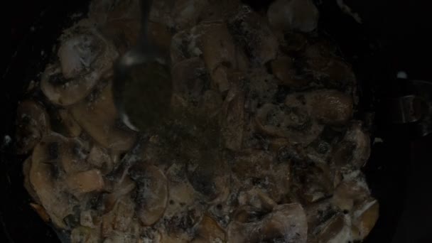 Stek vitlök och champinjoner svamp på en gammal gjutjärn pan — Stockvideo