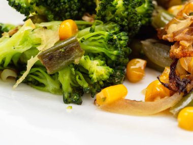 pişmiş sebze brokoli, havuç, yeşil fasulye, Mısır beyaz tabakta. Makro