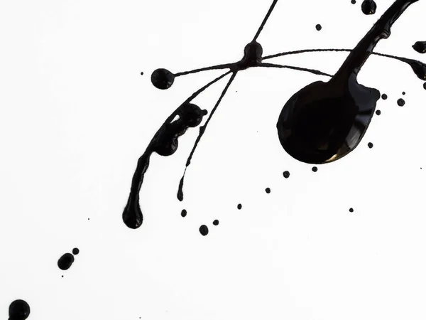 Spill drops black paint isolated on white background. Flowing fuel oil splashes, drops and trail — Stock Photo, Image