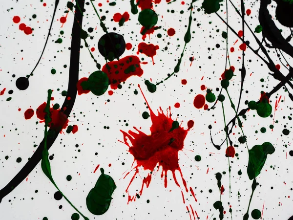 Splashes on red and black and green paint — Stock Photo, Image