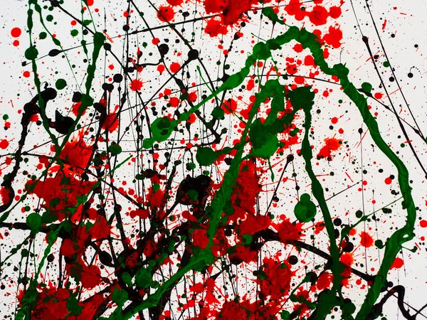 Splashes on red and black and green paint — Stock Photo, Image