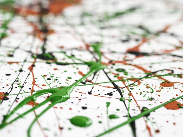 red black green paint splattered with lines and drops